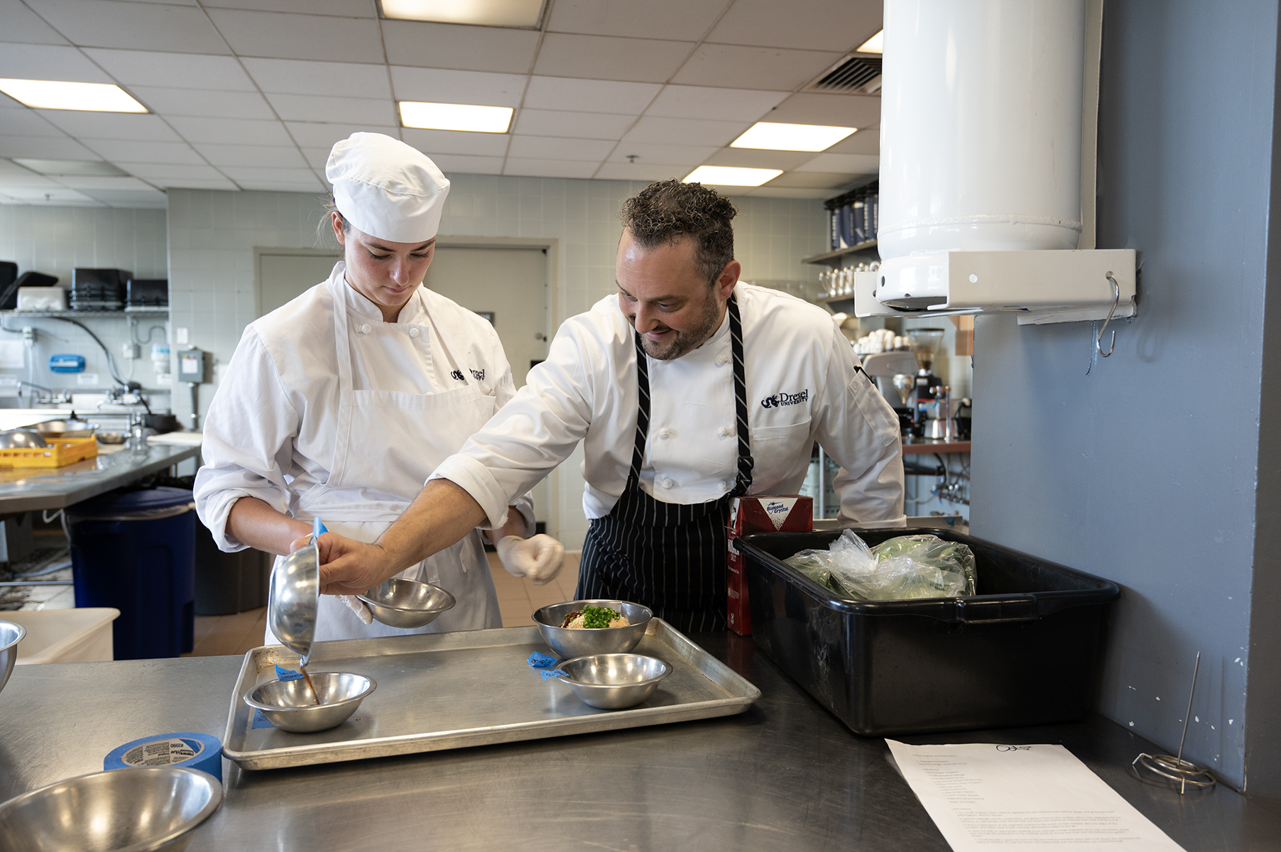Chef Richard Pepino helping student with dish 